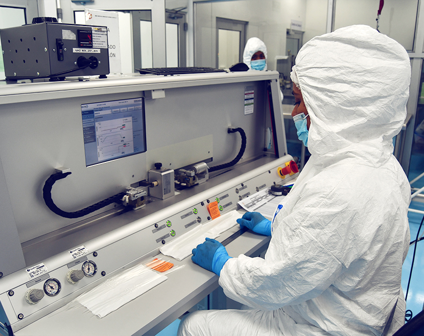Cleanroom operator manufacturing medical devices under controlled conditions