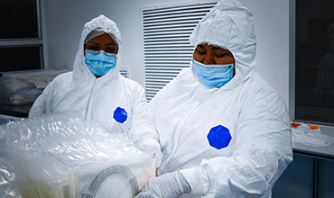 Cleanroom personnel preparing medical devices for sterilization